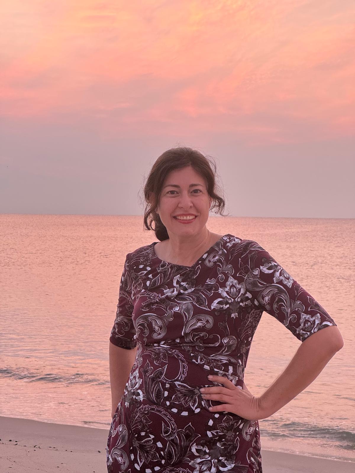 Suri Marozov smiling by the ocean
